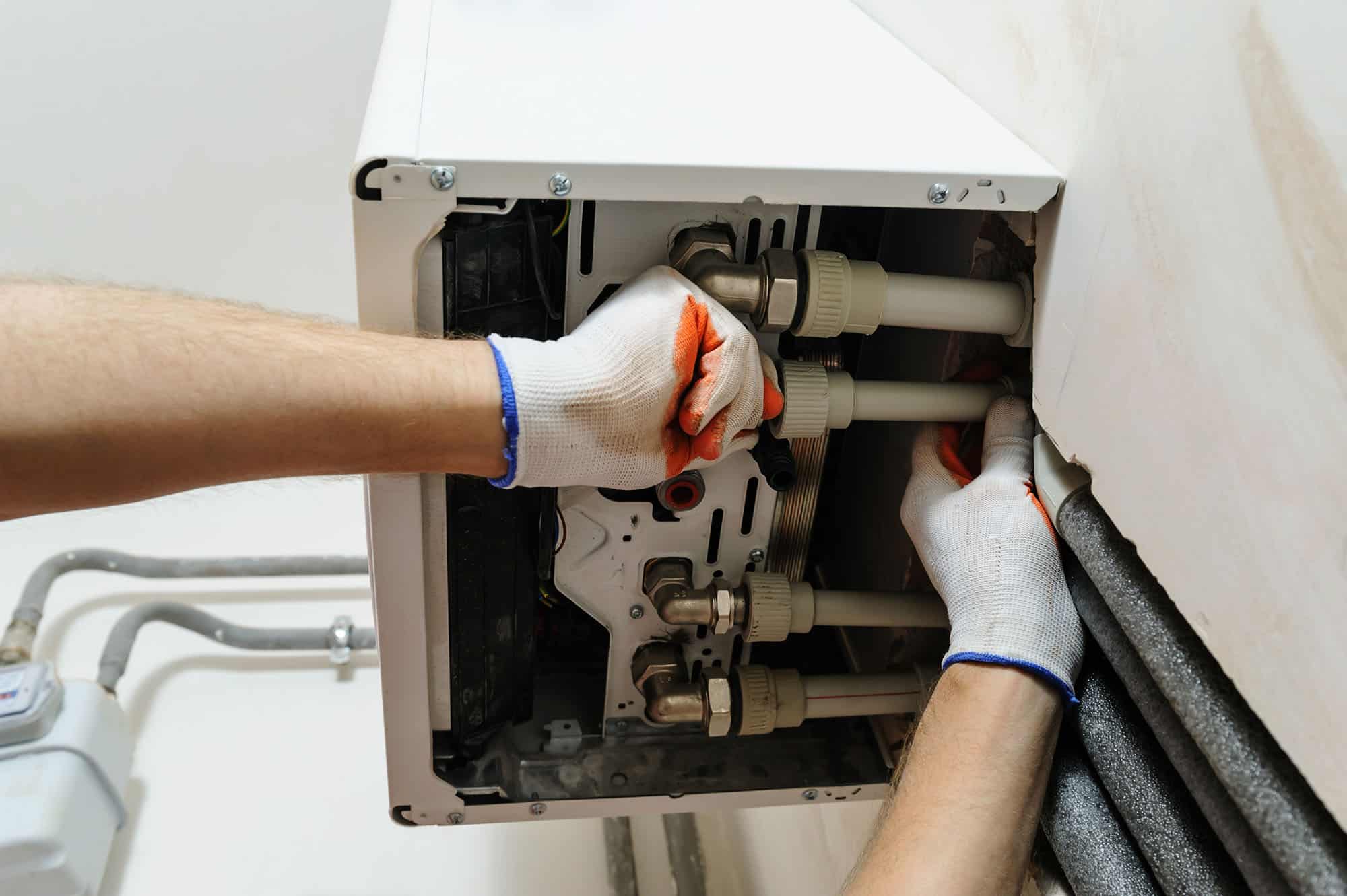 Heating engineer installing a domestic gas boiler.